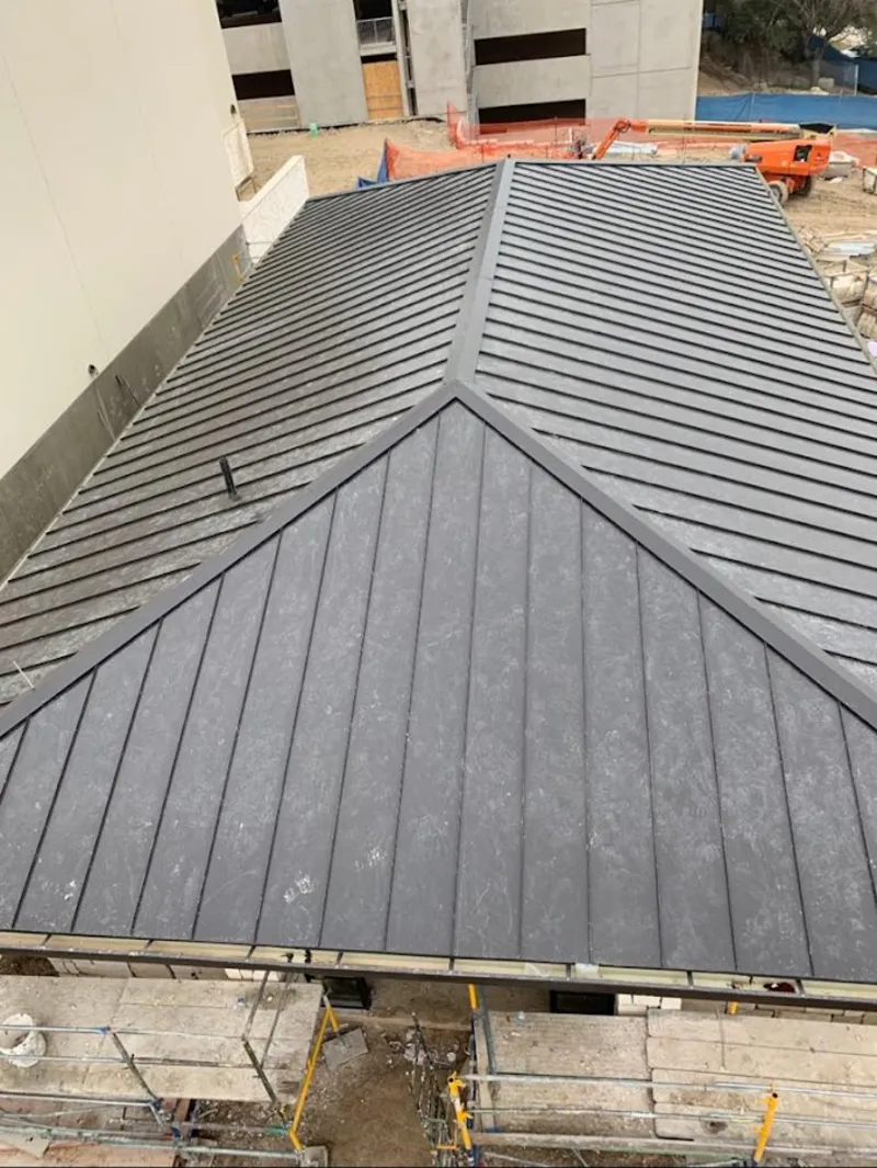 Commercial metal roof construction with crane equipment in Upper Moreland